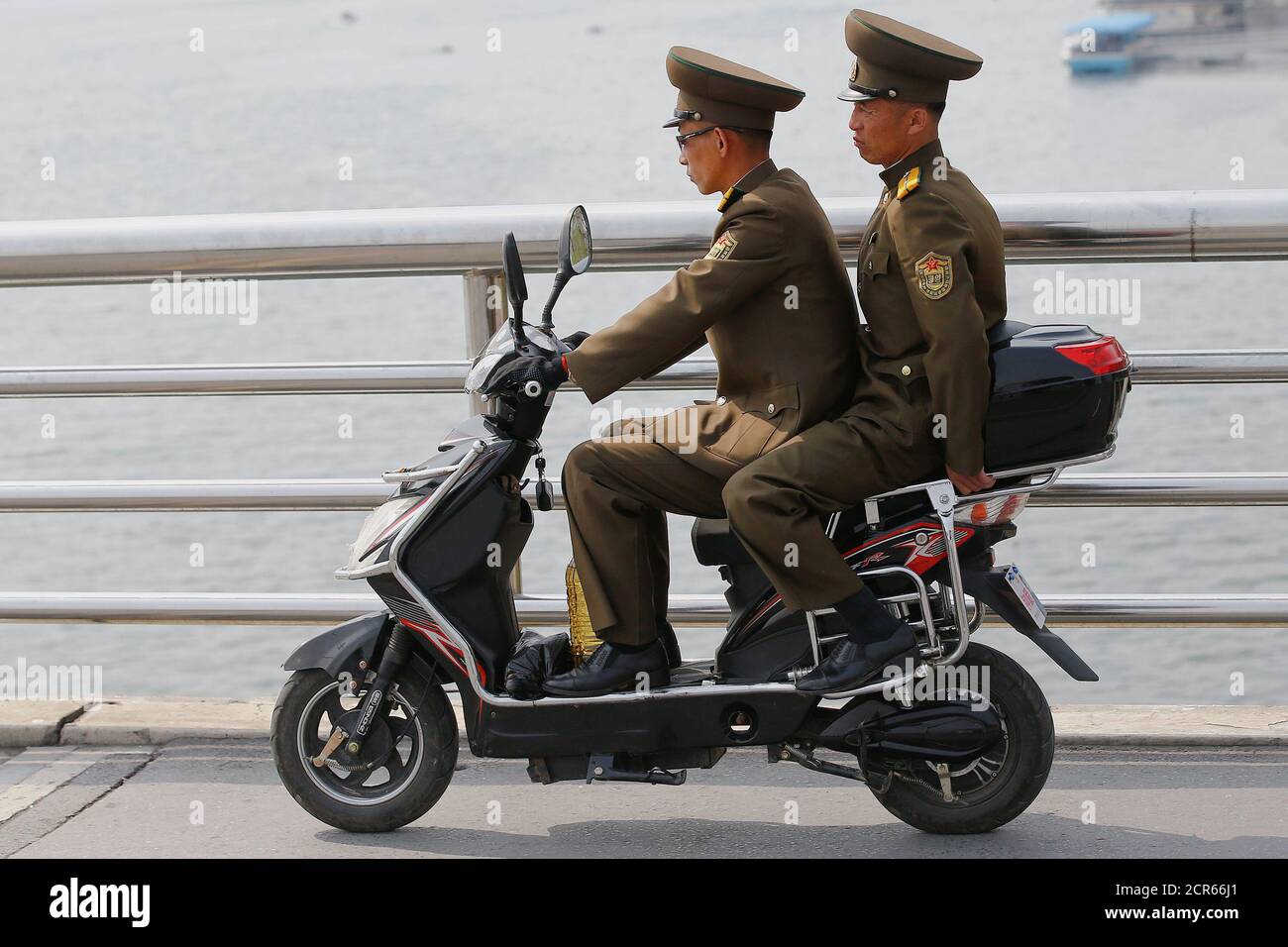 Soldiers cross the bridge on an electric scooter in central Pyongyang,  North Korea April 16, 2017. REUTERS/Damir Sagolj Stock Photo - Alamy