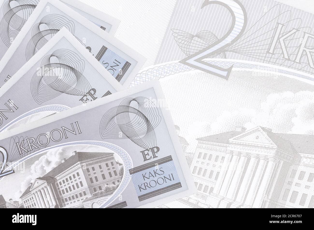 2 Estonian kroon bills lies in stack on background of big semi-transparent banknote. Abstract business background with copy space Stock Photo