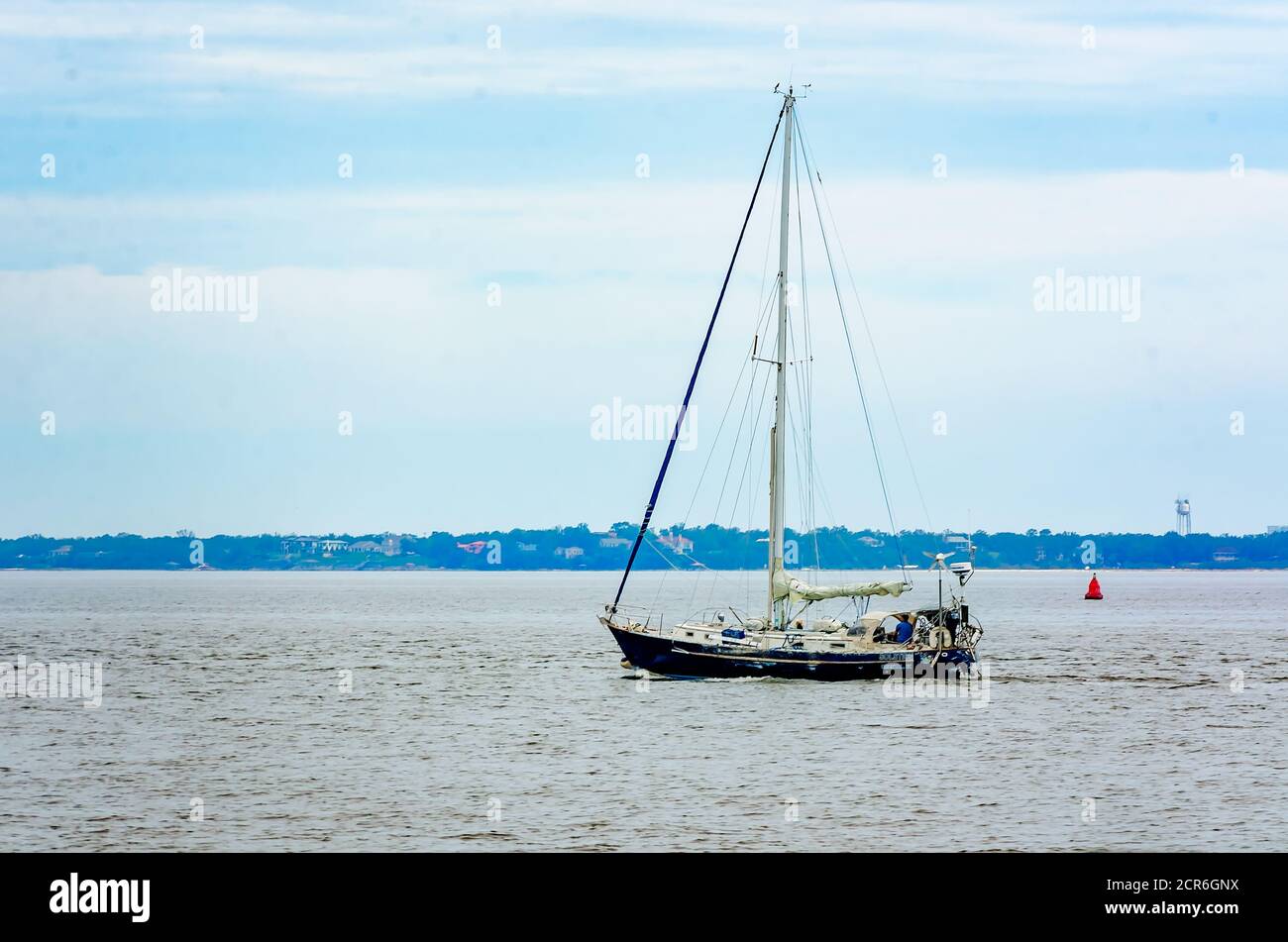 A sailboat passes Palafox Pier on Pensacola Bay, Sept. 18, 2020, in Pensacola, Florida. (Photo by Carmen K. Sisson/Cloudybright) Stock Photo