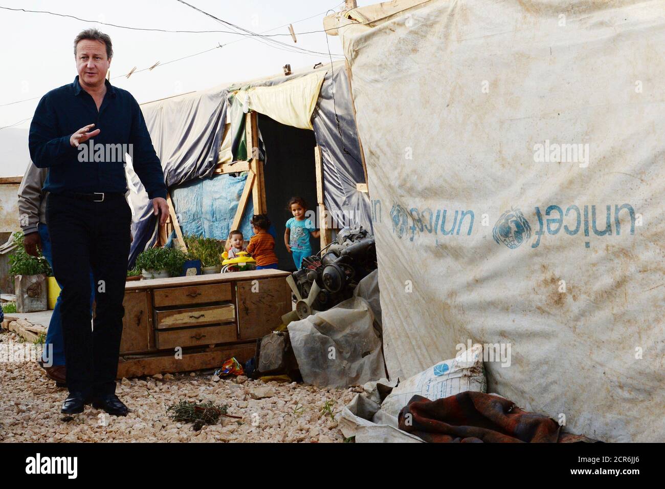 Prime Minister David Cameron visits a Syrian refugee settlement camp in the Bekaa Valley in Lebanon, September 14, 2015. British Prime Minister David Cameron arrived in Beirut on Monday to visit refugees from the war in neighbouring Syria, which has driven well over a million people into Lebanon and tens of thousands towards Europe, Lebanese media reported. Cameron will visit refugees and then meet with his Lebanese counterpart Tammam Salam. Lebanon, where one in every four people is a refugee, is hosting the greatest number of refugees per capita of any country in the world. It has called on Stock Photo