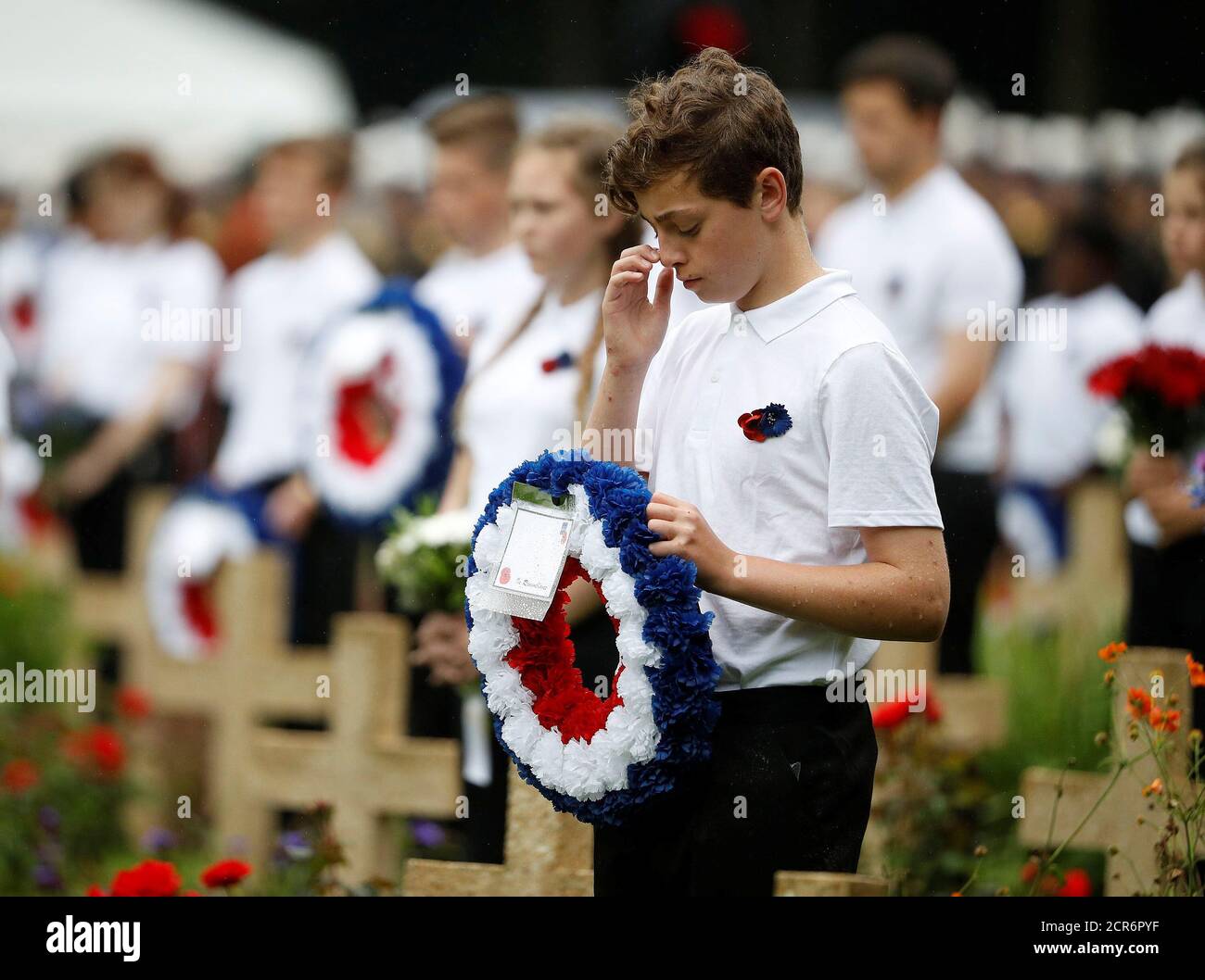 School children hold wreaths as they attend a commemoration event at the Thiepval memorial to mark the 100th anniversary of the Battle of the Somme in Thiepval, northern France July 1, 2016.  REUTERS/Phil Noble Stock Photo
