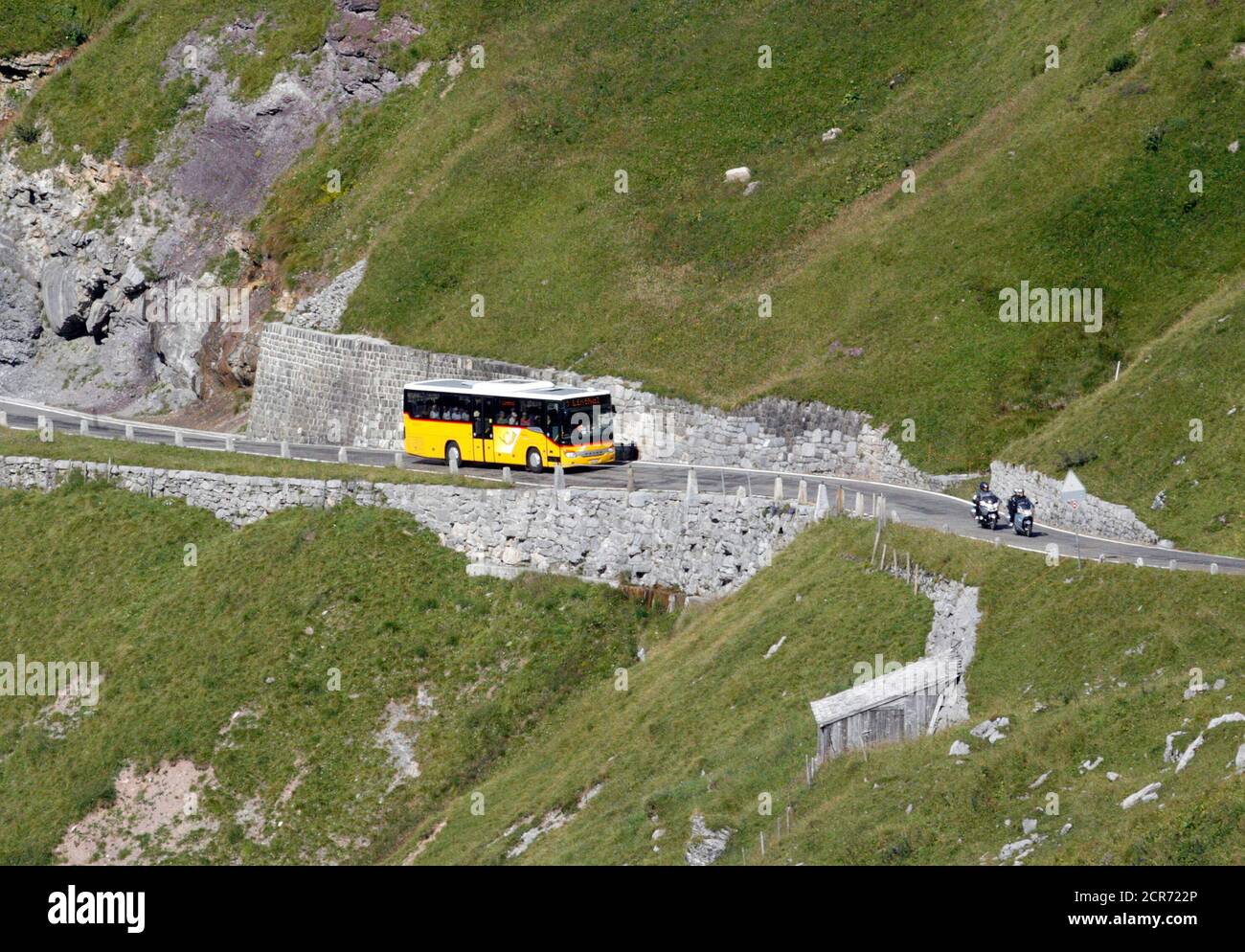 A Swiss Postauto bus drives past on the Klausenpass mountain pass, 1,952 m  (6,404 ft) in the Swiss Alps August 19, 2009. The bus transport of Switzerland's  post is leading in the