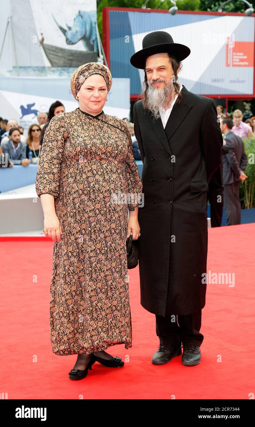 Director Rama Burshtein (L) poses on the red carpet with an unidentified  guest during a screening for the movie "Lemale et ha' chalal (Fill the  void)" at the 69th Venice Film Festival