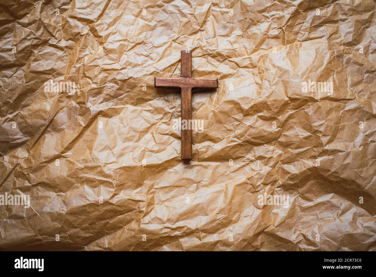 Simple wooden religious cross on brown paper background Stock Photo - Alamy