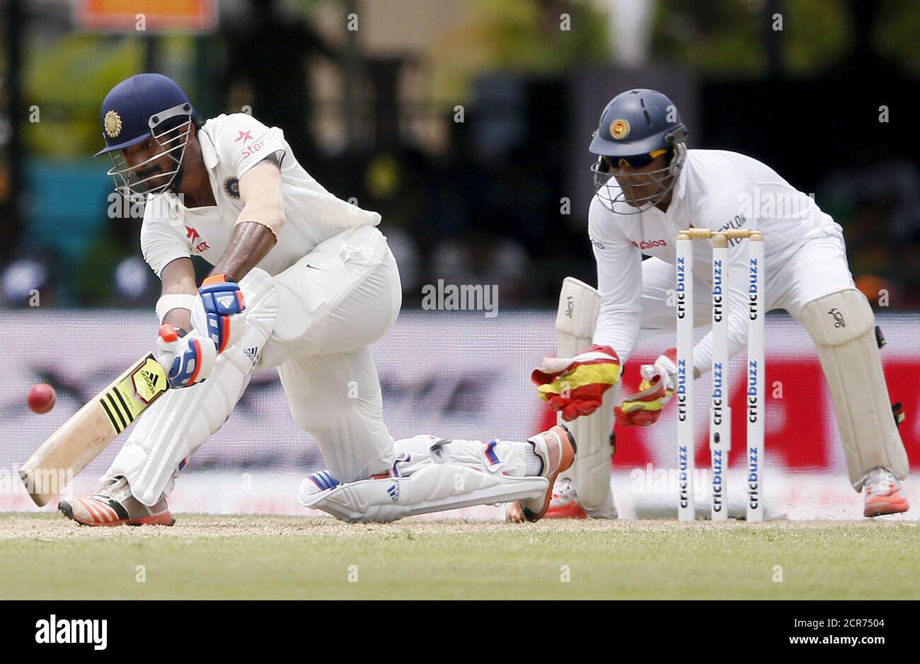 India's Lokesh Rahul (L) plays a shot next to Sri Lanka's wicketkeeper Dinesh Chandimal during the first day of their second test cricket match in Colombo, August 20, 2015. REUTERS/Dinuka Liyanawatte Stock Photo