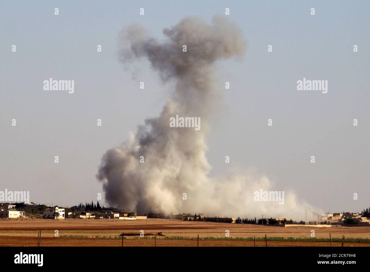 Smoke rises from airstrikes on Guzhe village, northern Aleppo countryside, Syria October 17, 2016. REUTERS/Khalil Ashawi Stock Photo