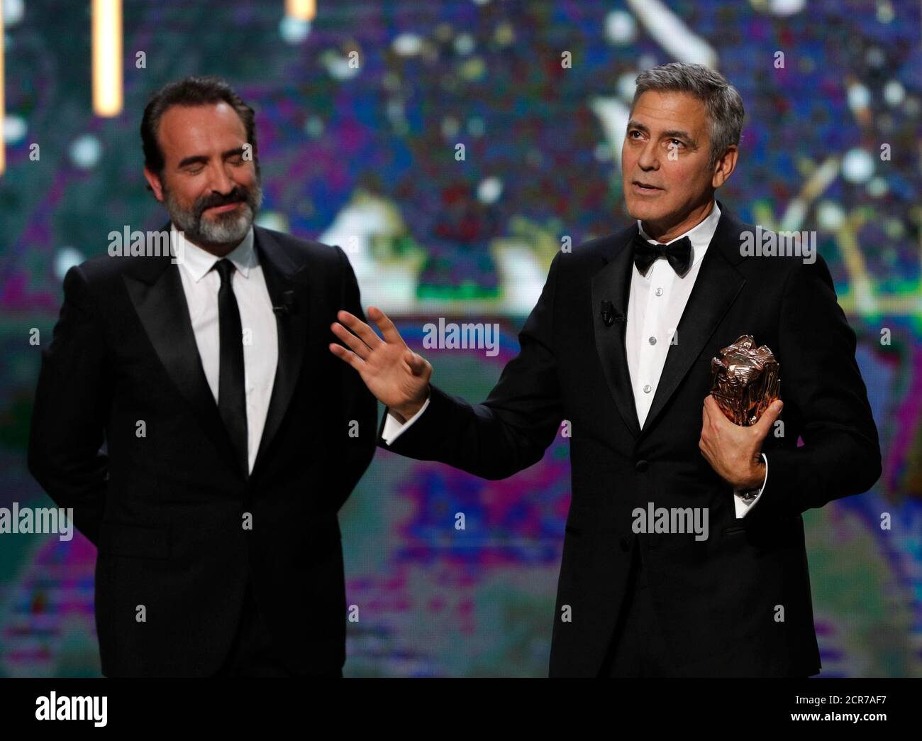 Actor George Clooney (R) delivers a speech next to actor Jean Dujardin as  he receives an Honorary Cesar Award at the 42nd Cesar Awards ceremony in  Paris, France, February 24, 2017. REUTERS/Philippe