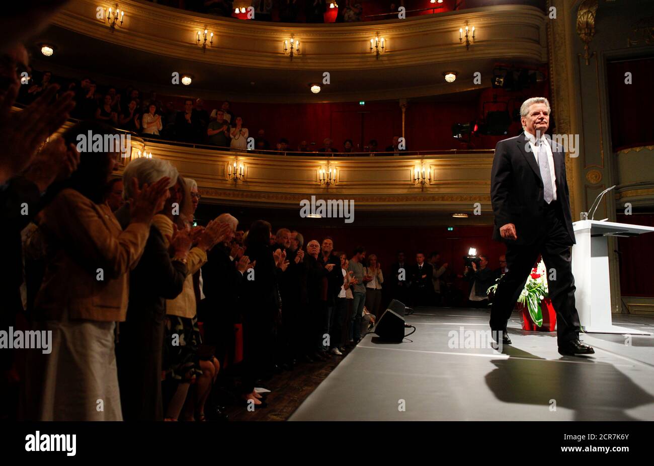 People applaud German presidential candidate Gauck after his speech in the Deutsches Theater (German Theatre) in Berlin, June 22, 2010. The vote for the largely ceremonial post of German president is shaping up as a big test for Chancellor Angela Merkel who has been dogged by falling popularity, policy spats in her centre-right coalition and accusations of weak leadership. A failure by Merkel to push through the conservative candidate Christian Wulff, the premier of the state of Lower Saxony, would be widely viewed as a major defeat for her. Joachim Gauck, a former Protestant pastor who played Stock Photo