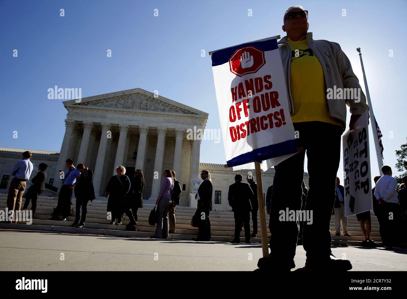 Demonstrators rally during oral arguments in Gill v. Whitford, a case