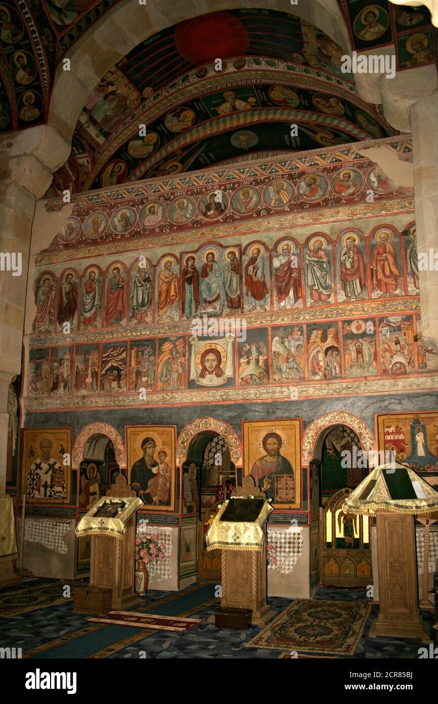 Borzești Orthodox Church in Onești, Bacău County, Romania. The iconostasis covered in frescoes with New Testament scenes and characters. Stock Photo
