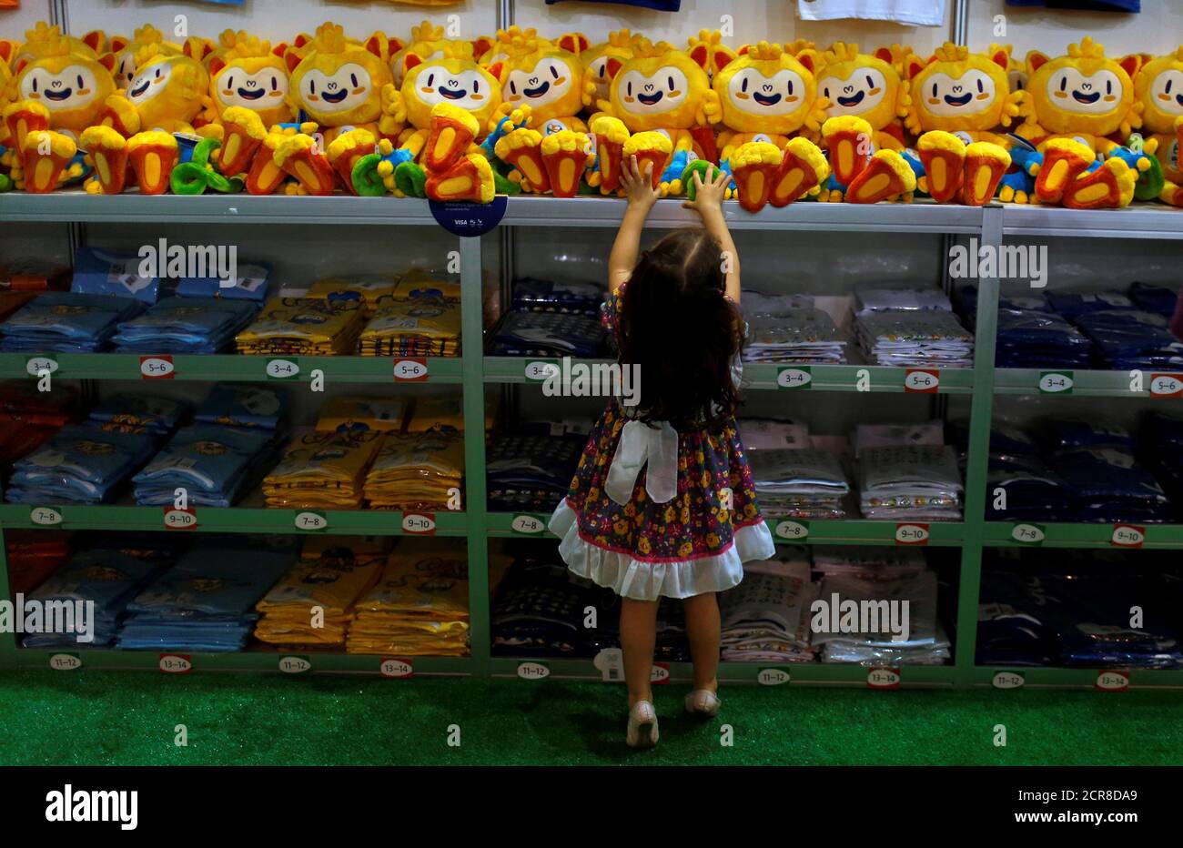 A Child Tries To Reach A Rio 16 Olympic Mascot Vinicius Doll During The Opening Of The Olympics Megastore On Copacabana Beach In Rio De Janeiro Brazil June 30 16 Reuters Pilar Olivares