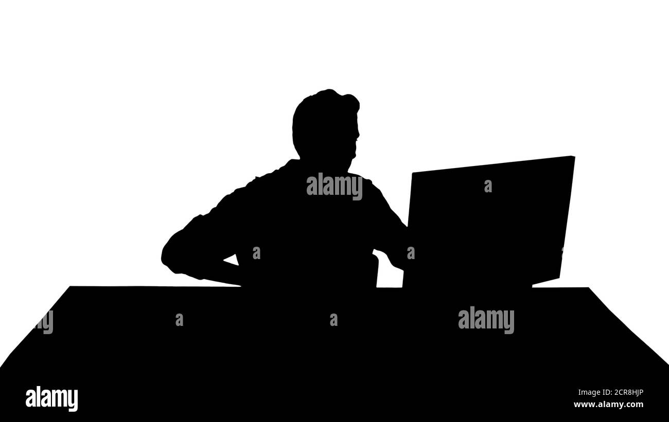 Silhouette Nervous man watching video games on a PC computer. Stock Photo