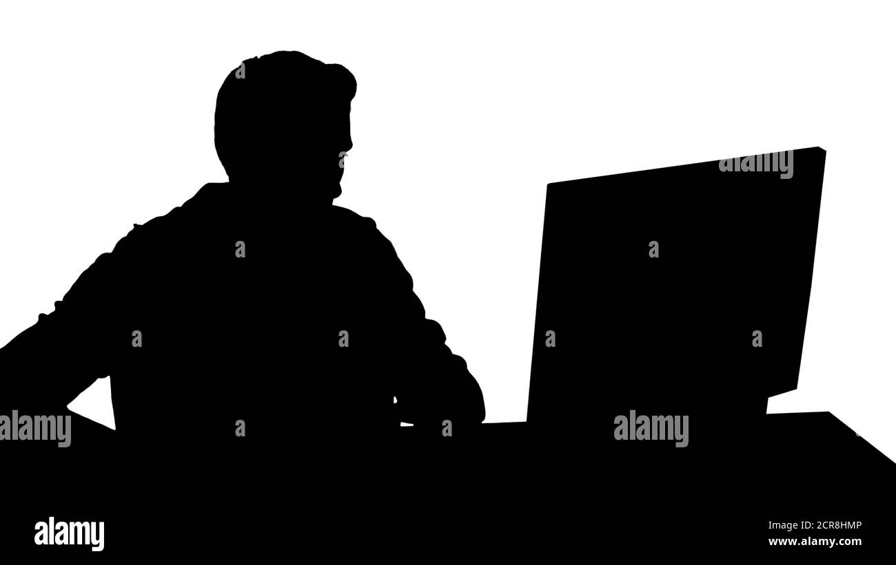 Silhouette Gamer playing a video game on personal computer. Stock Photo