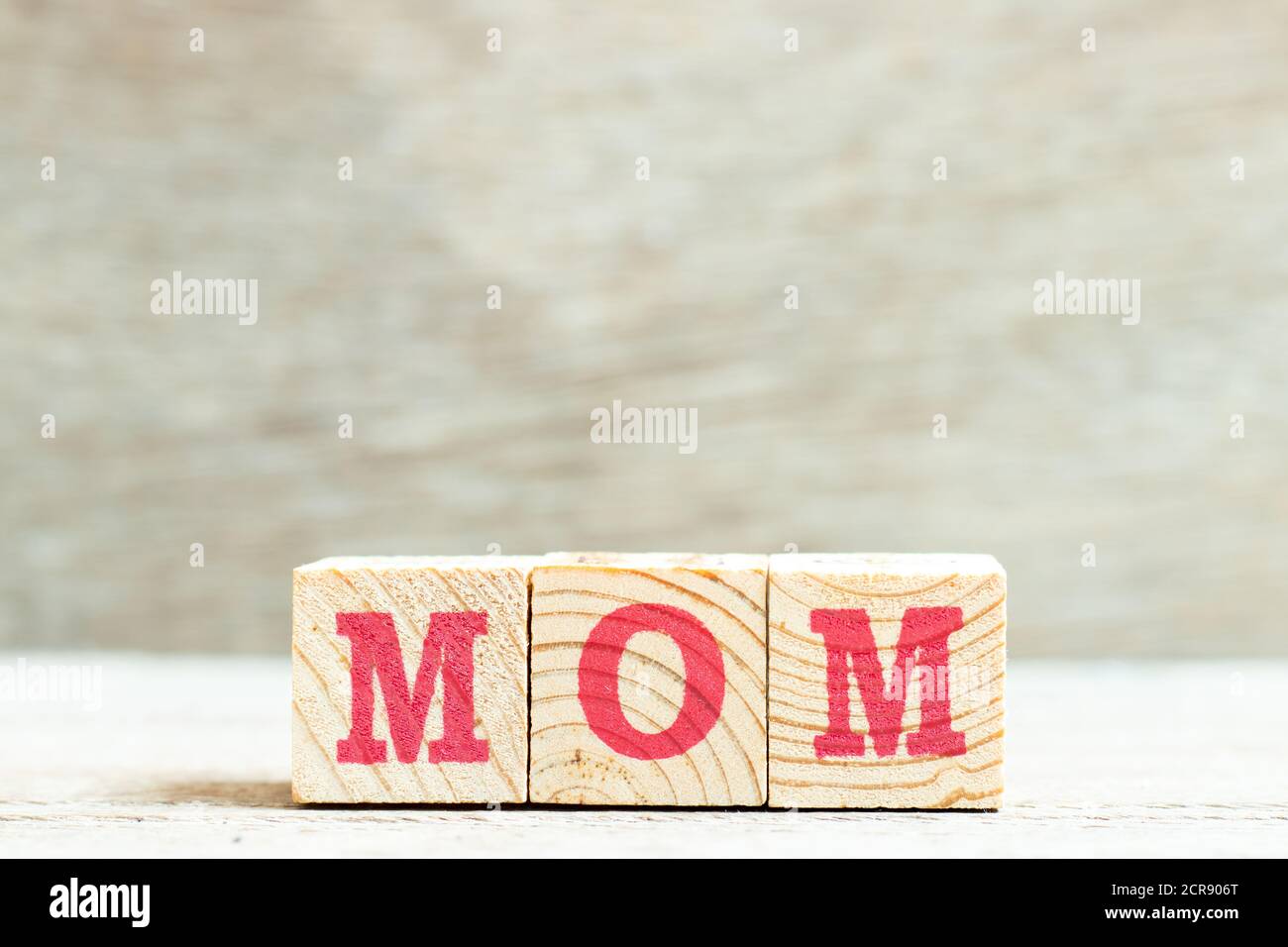 Alphabet letter block in word mom on wood background Stock Photo - Alamy