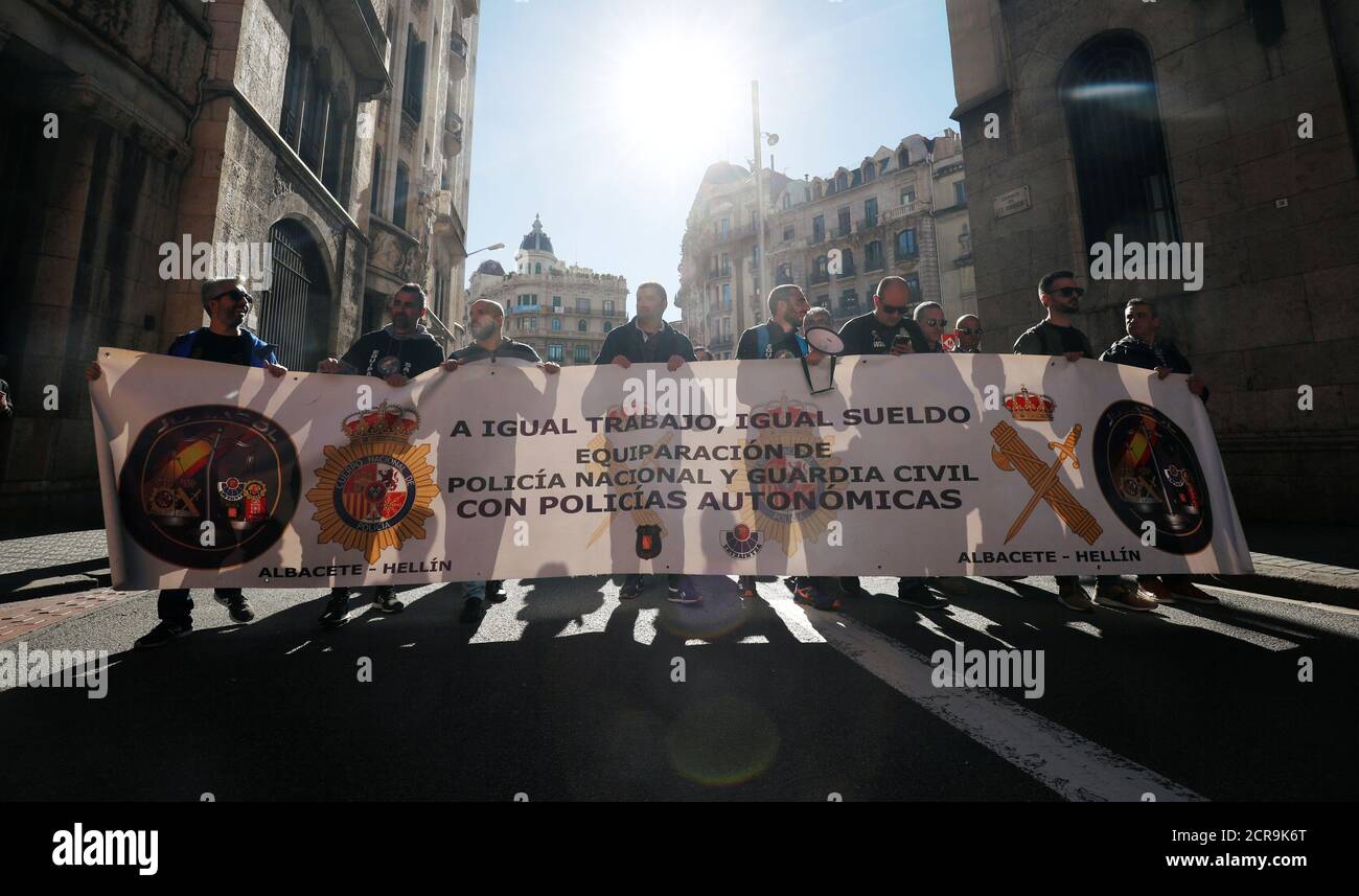 Members of Spanish police unions take part in a rally organised by Jusapol Foundation demanding better wages in Barcelona, Spain November 10, 2018. The banner reads 'Same job, same wage. Equalization of National Police, Civil Guard and Regional Police'. REUTERS/Albert Gea Stock Photo