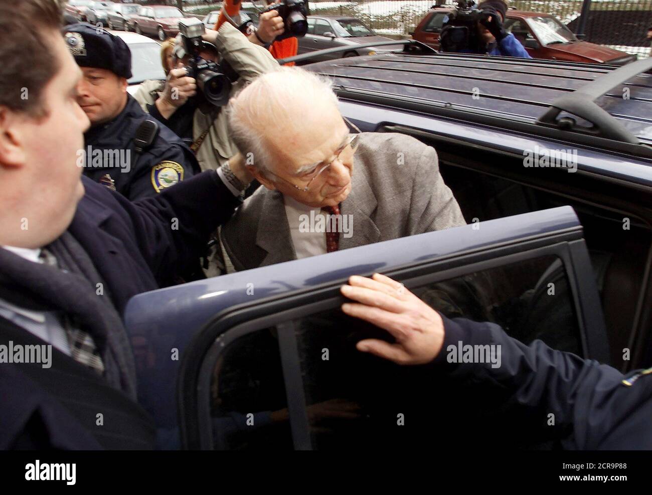 Roman Catholic Reverand Paul Shanley, awaiting trial on charges he abused young boys while a priest in the Boston Archdiocese, ducks into an SUV as he leaves the Middlesex Superior Courthouse freed on bail December 11, 2002 in Cambridge, Massachusetts. Shanley was freed after posting $300,000 cash bail raised by friends, relatives and supporters to be freed while awaiting trial. REUTERS/Jim Bourg REUTERS  JRB Stock Photo