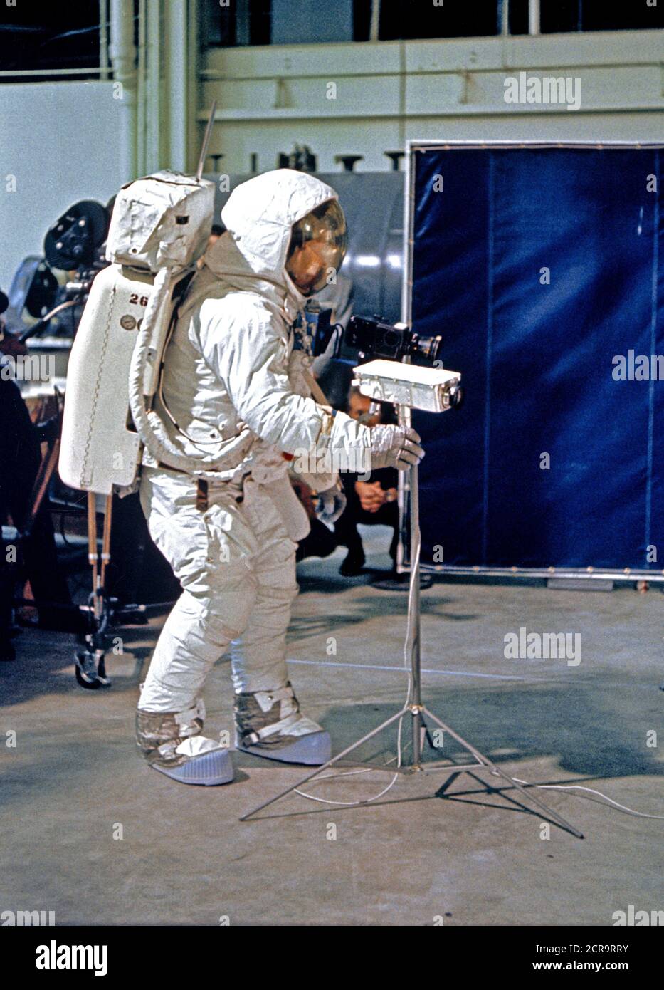 Astronaut Neil A. Armstrong, wearing an Extravehicular Mobility Unit (EMU), deploys a lunar surface television camera during lunar surface simulation training Stock Photo