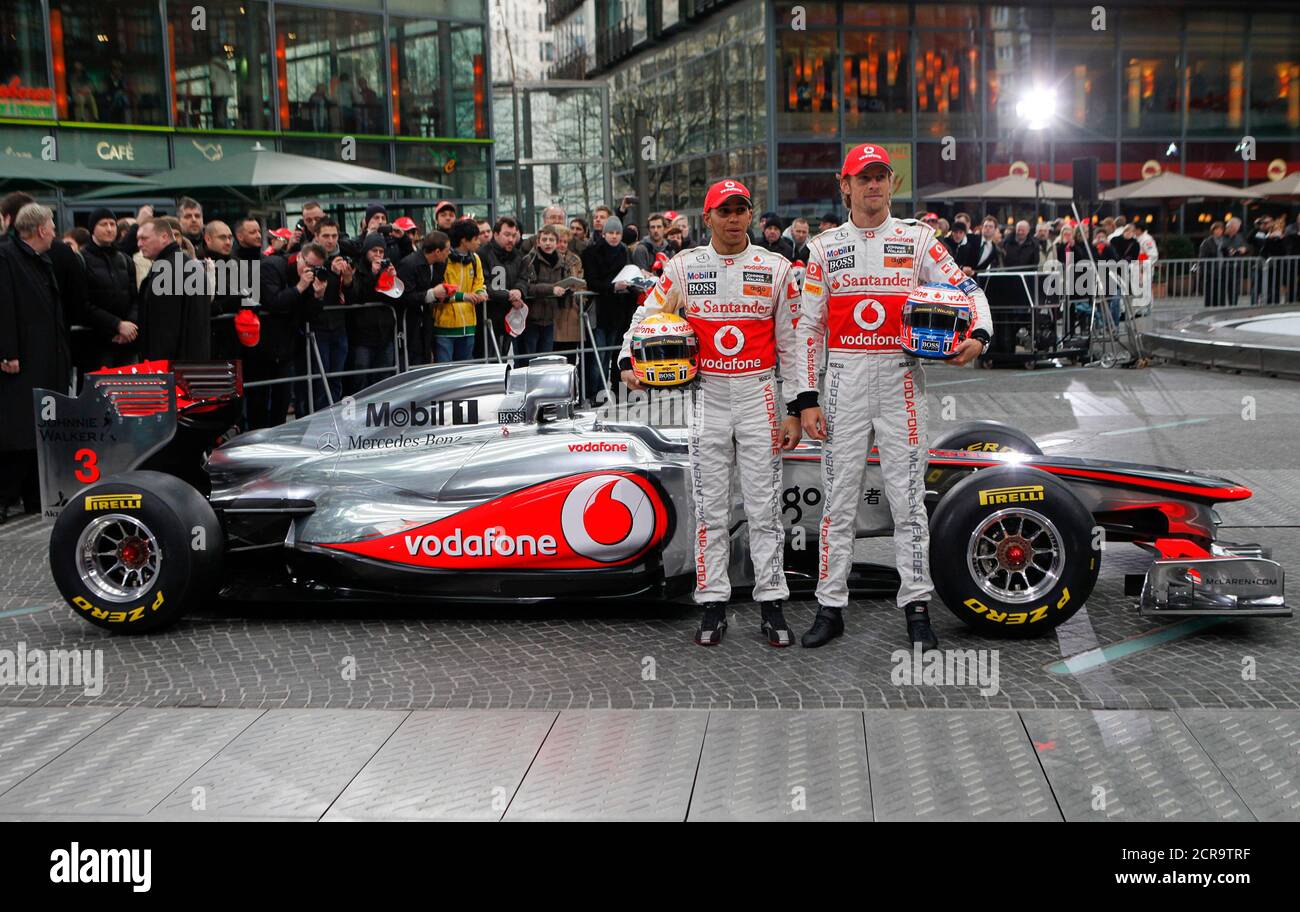 McLaren Formula One racing drivers Lewis Hamilton and Jenson Button of  Britain pose for pictures during the revealing of the F1 McLaren Mercedes  MP4-26 racing car in Berlin, February 4, 2011. REUTERS/Thomas