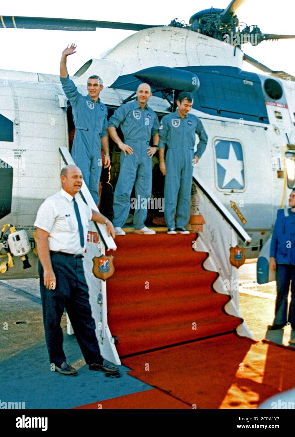 Apollo 10 astronauts Thomas P. Stafford (center), John W. Young (left) and Eugene A. Cernan (waving) are greeted by Donald E. Stullken (lower left) of the Manned Space Center's (MSC) recovery team Stock Photo