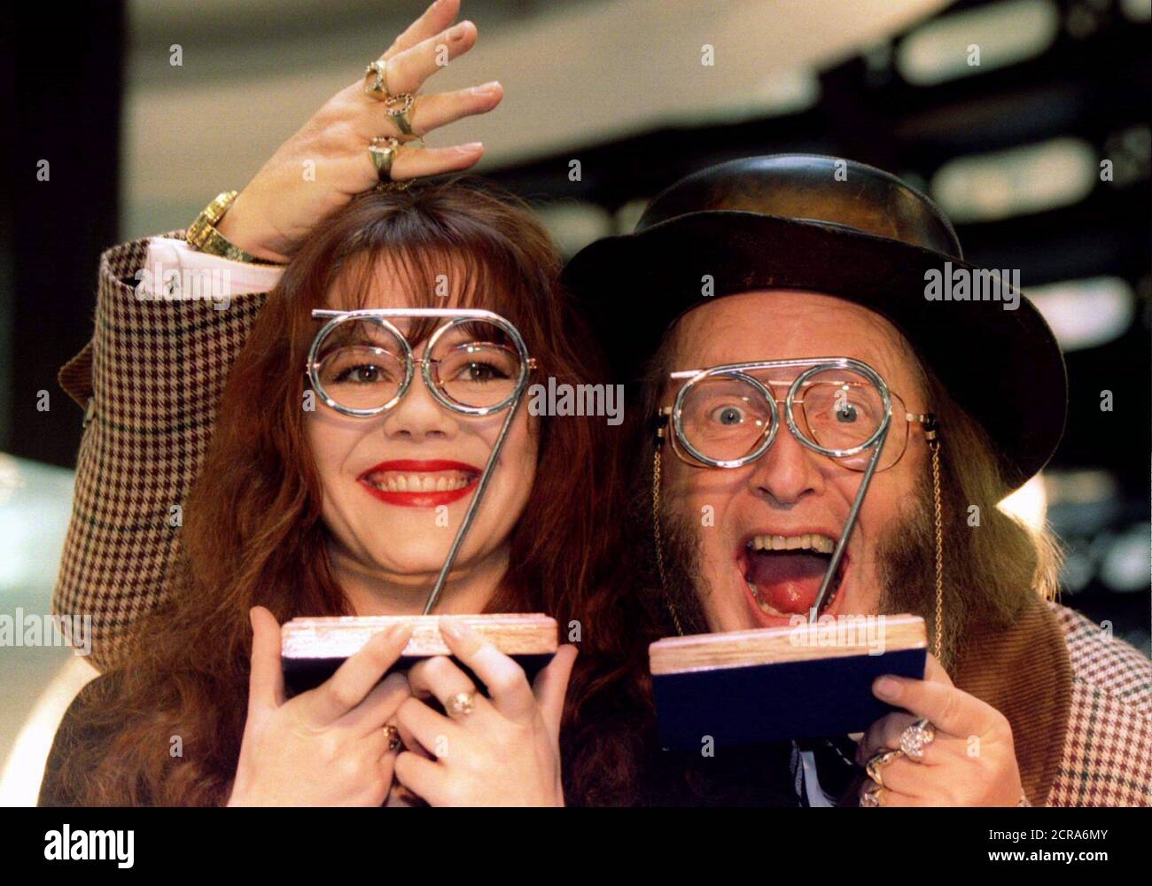 Comedienne Josie Lawrence and horse-racing expert John McCririck show off their Spectacle Wearer of the Year Awards following a ceremony in central London March 25. The awards coincided with the opening of an exhibition designed to aid the charity Vision Aid Overseas.  SPECTACLES Stock Photo