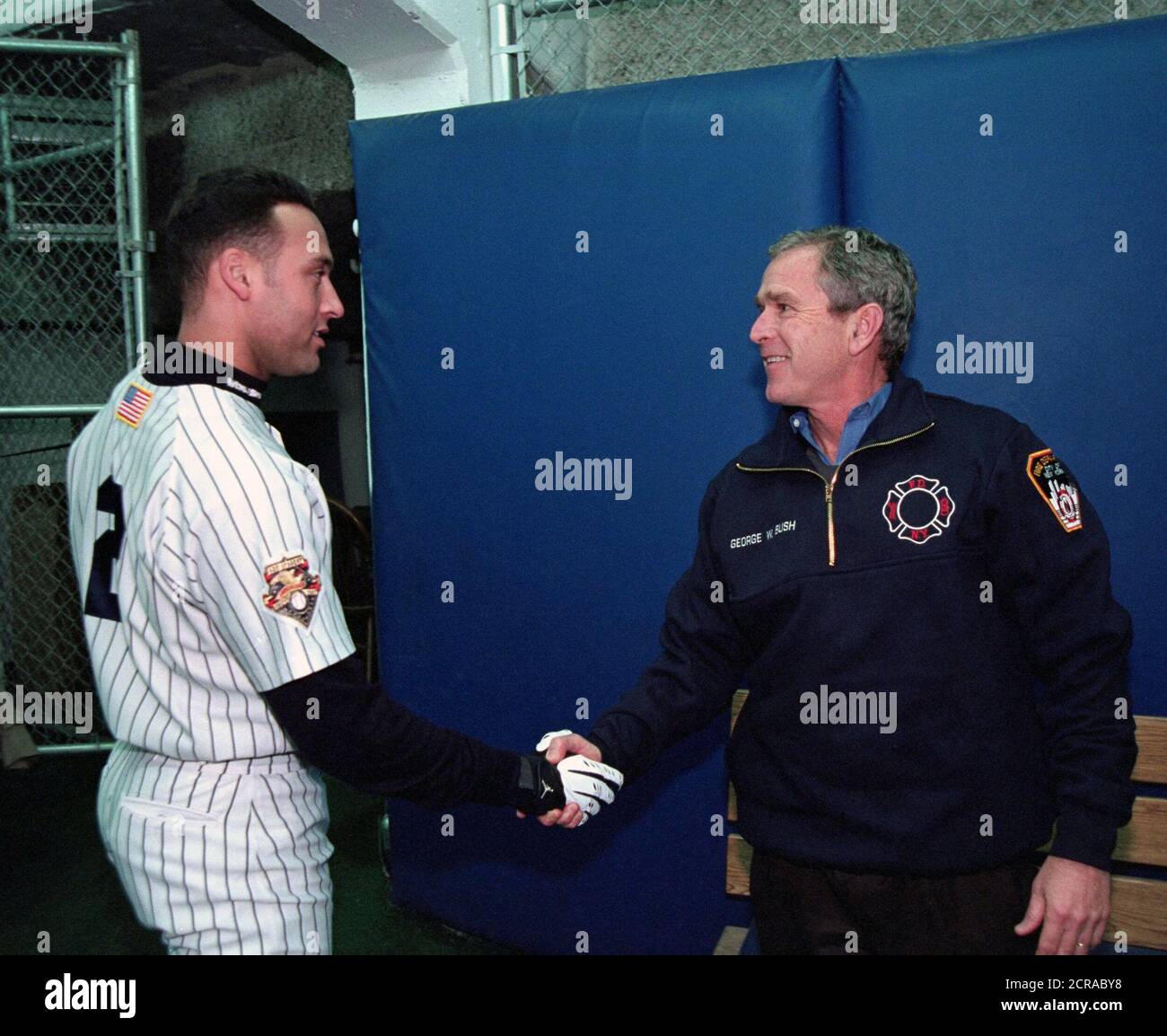 President George W. Bush shakes hands with Yankee shortstop Derek Jeter Tuesday Oct. 30, 2001, prior to throwing out the ceremonial first pitch in Game Three of the World Series between the Arizona Diamondbacks and the New York Yankees at Yankee Stadium in New York City. Stock Photo