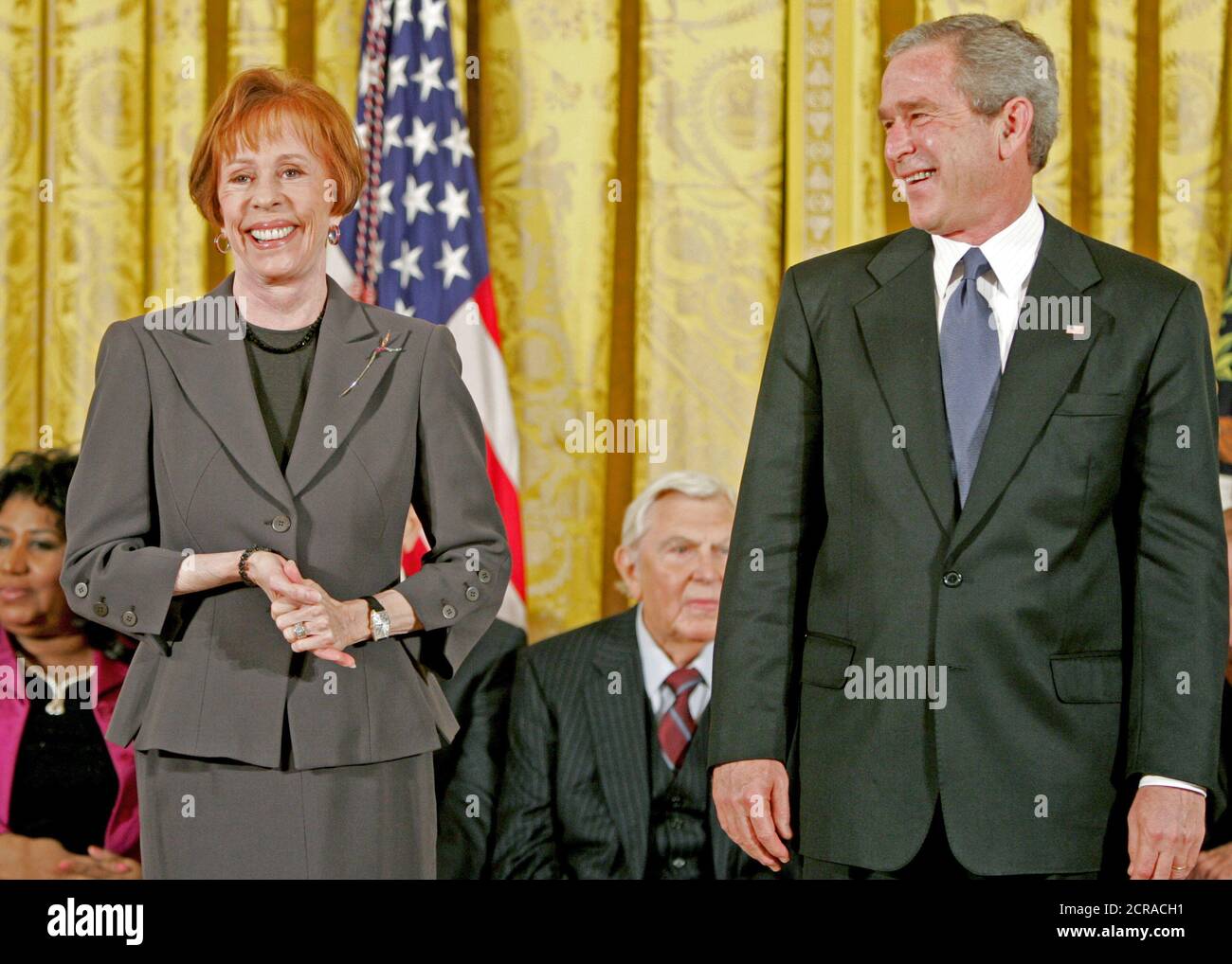 Carol Burnett jokes with President George W. Bush during the presentation of the Presidential Medal of Freedom to in the East Room Wednesday, Nov. 9, 2005. As a singer, dancer, comedienne, and actress, she has been one of America’s most cherished entertainers since her Broadway by in 1959. Photo by Paul Morse, Courtesy of the George W. Bush Presidential Library Stock Photo