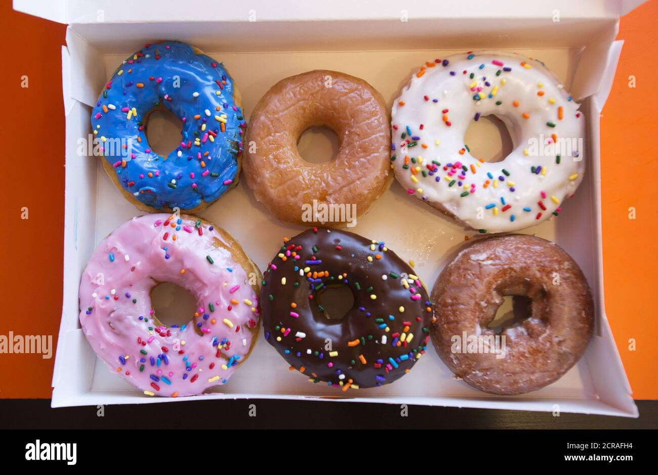 A box of donuts, (from top L clockwise) manager's special, traditional  glazed, vanilla, pumpkin, chocolate and strawberry, is pictured at a newly  opened Dunkin' Donuts store in Santa Monica, California September 2,