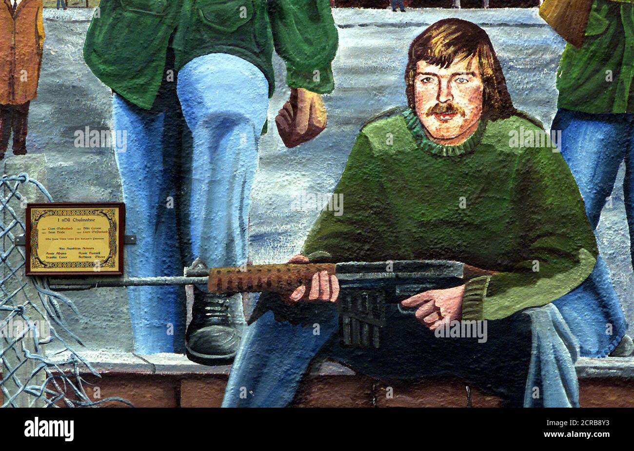 New colourful Irish Republican murals drawn on the walls of Ballymurphy, west Belfast, Northern Ireland, 10 August, 2002. The murals show IRA volunteers patroling the west Belfast streets during the troubles carry weapons. REUTERS/Paul McErlane  PM Stock Photo