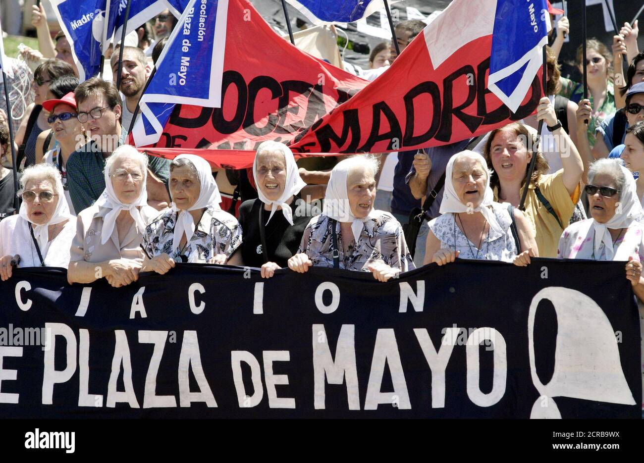 Members of the Argentina's humans rights group Madres de Plaza de Mayo march during a rally to commemorate the second anniversary of Fernando de la Rua's resignation of the presidency, in Buenos