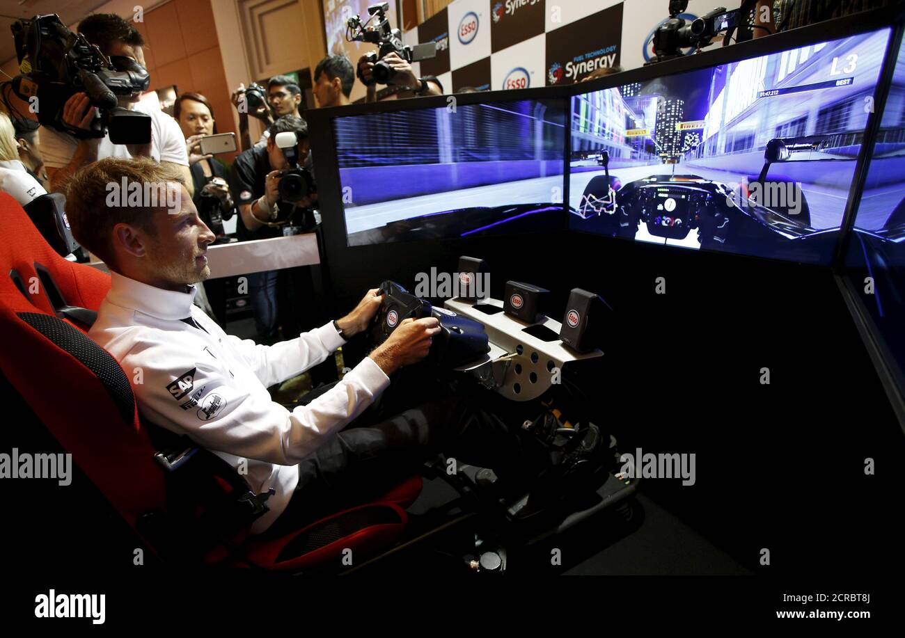 McLaren Formula One driver Jenson Button of Britain races in a virtual simulator during publicity events ahead of the Singapore F1 night race in Singapore September 16, 2015. The Singapore F1 Grand Prix night race takes place from September 18, 2015. REUTERS/Edgar Su Stock Photo