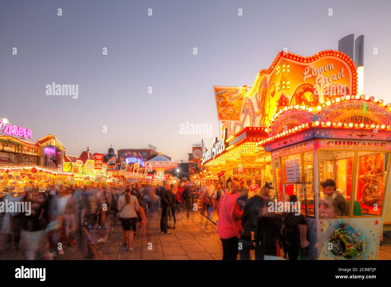 Stalls and fairground rides on the Bremer Freimarkt at dusk, Bremen, Germany, Europe Stock Photo