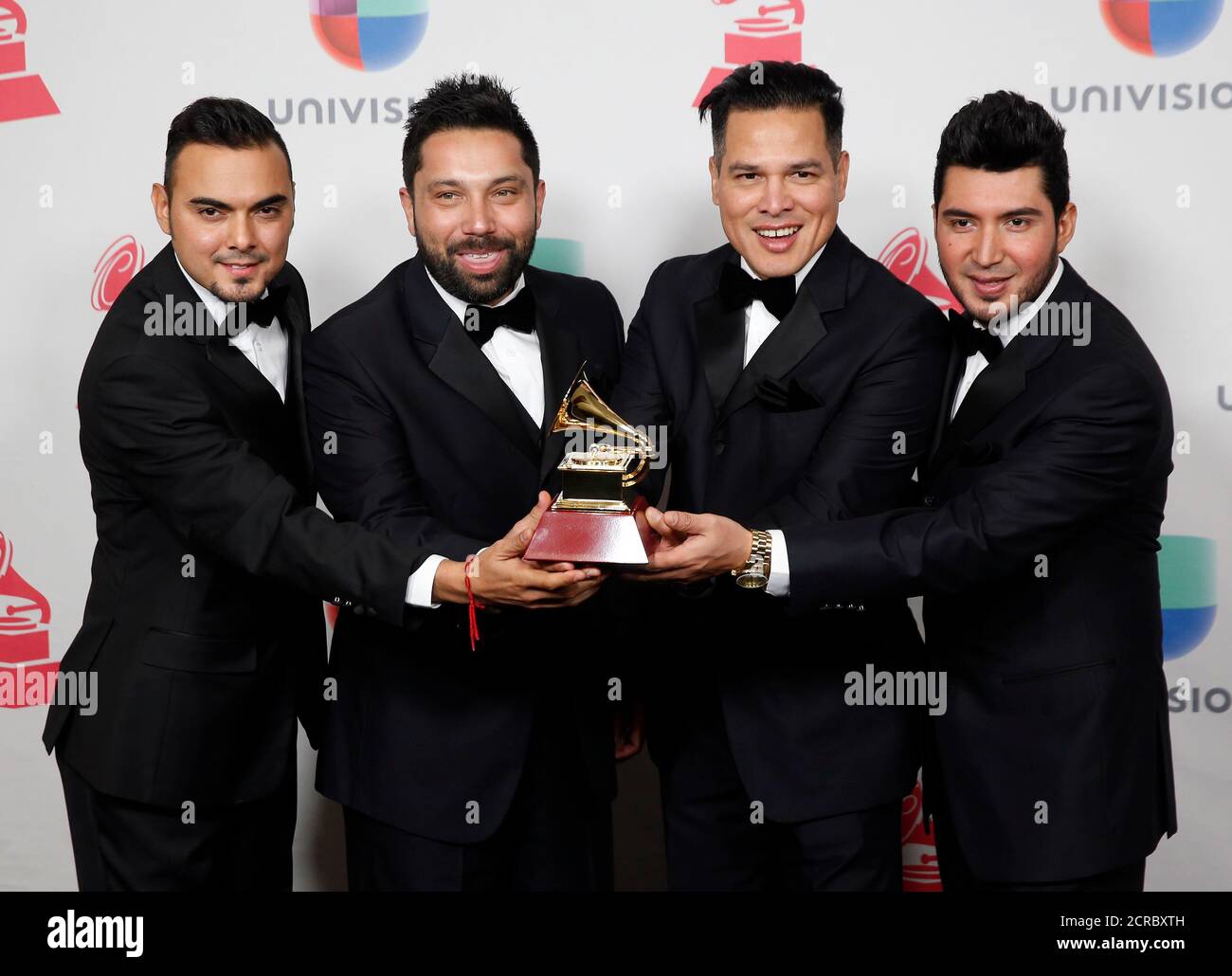 Banda El Recodo De Cruz Lizarraga poses with their award for Best Banda  Album for 