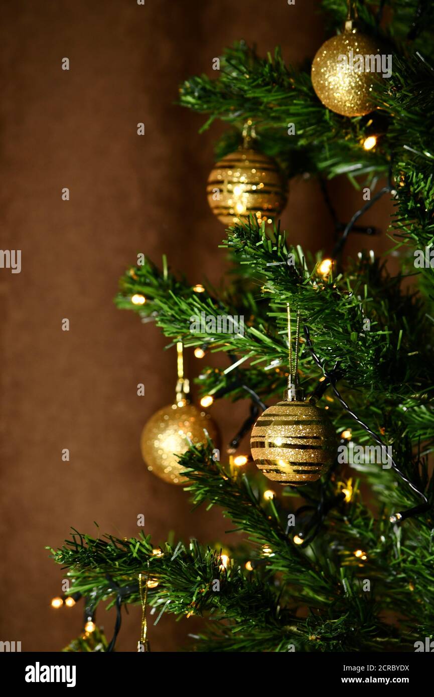 Christmas tree with golden balls and a luminous garland, with focus in ...