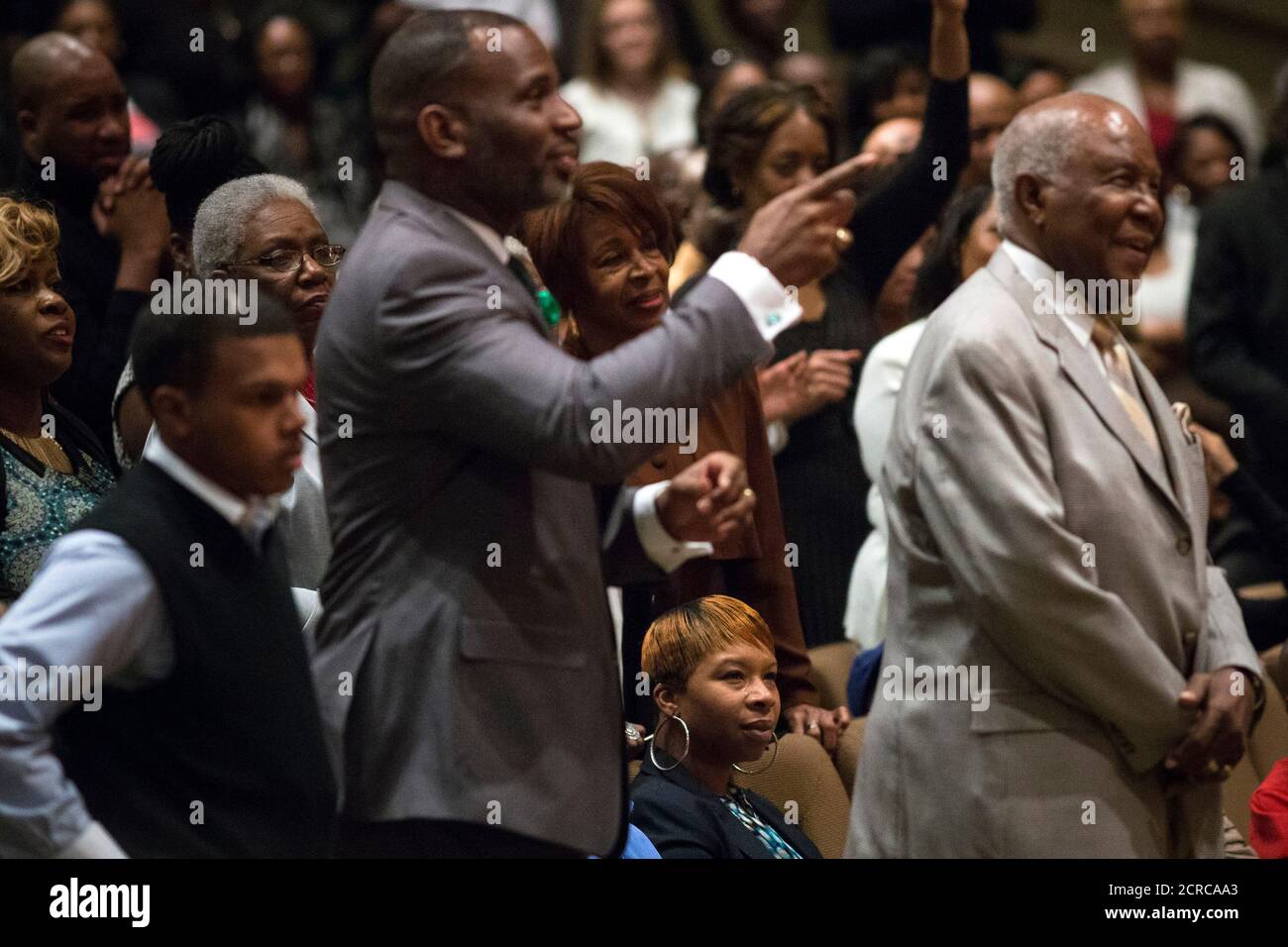 Michael Brown's mother Lesley McSpadden (seated) watches veteran civil rights activist Rev. Al Sharpton speak at the Friendly Temple Missionary Baptist Church in St. Louis, Missouri November 30, 2014. Sharpton preached on Sunday to a congregation of some 2,500 worshippers at the St. Louis church where Michael Brown's funeral was held in August. The dead teen's parents were among the congregation. REUTERS/Adrees Latif (UNITED STATES - Tags: CRIME LAW CIVIL UNREST POLITICS RELIGION) Stock Photo