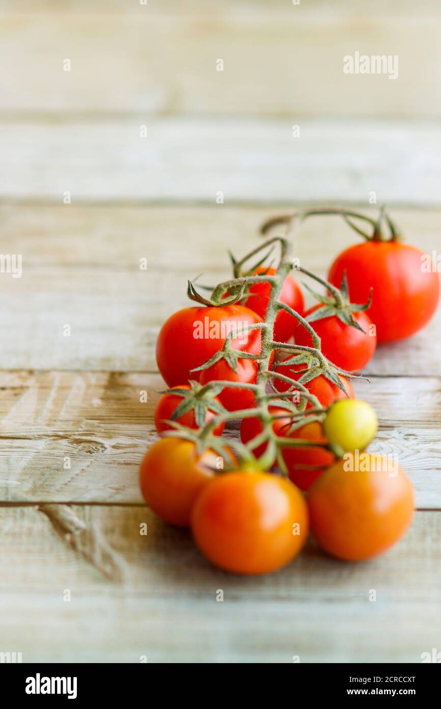 View of beautiful red cherry tomatoes on wooden background Stock Photo