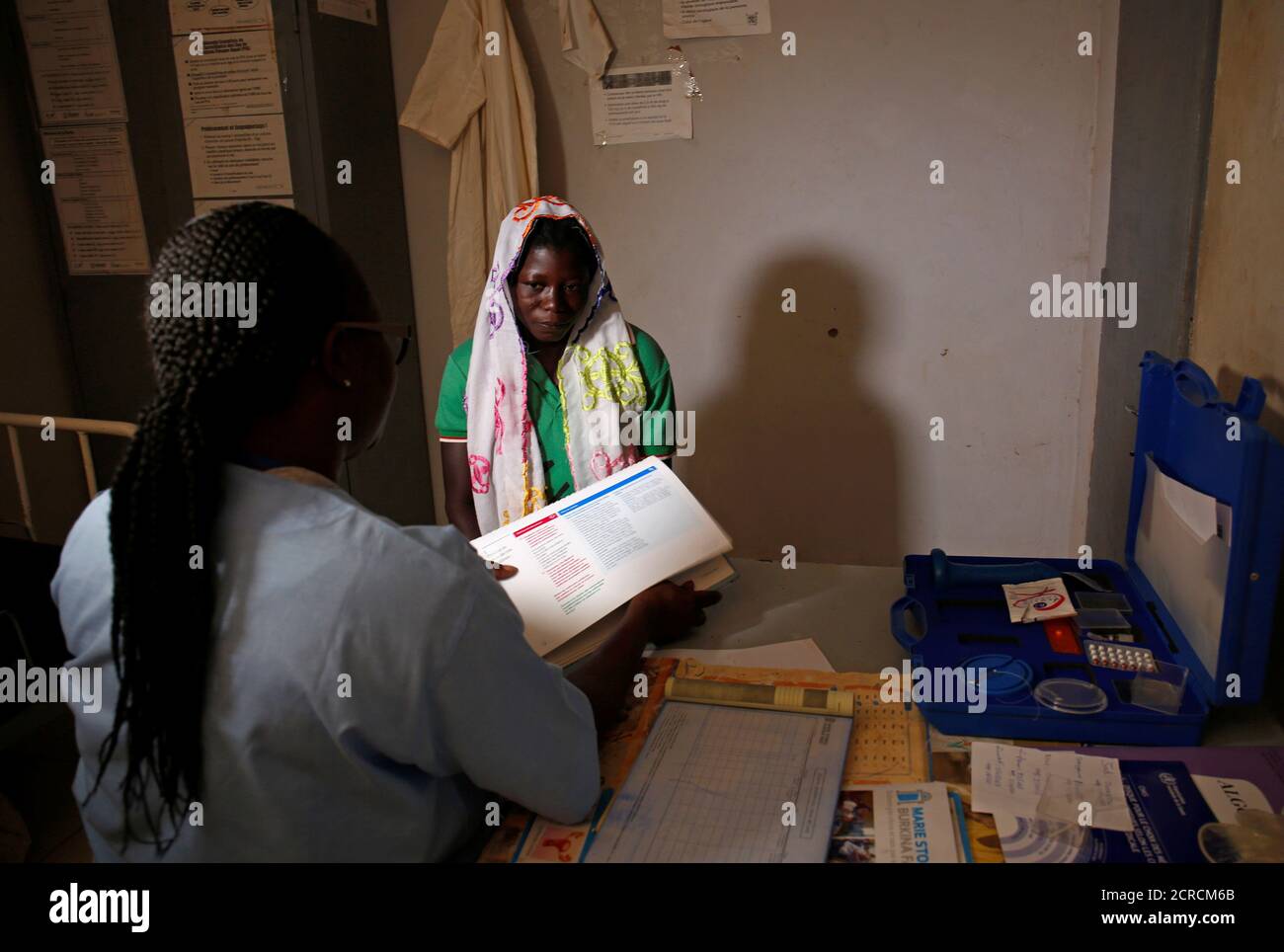 A nurse from Marie Stopes NGO chats with a woman at a dispensary in the village of Nedgo, near Ouagadougou, Burkina Faso February 16, 2018. Picture taken February 16, 2018. REUTERS/Luc Gnago Stock Photo