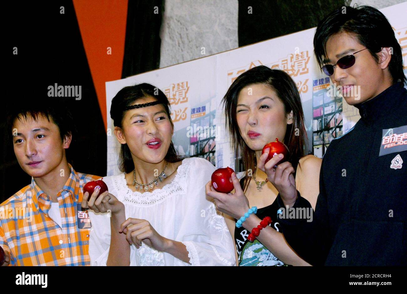 Hong Kong singers, from left to right, Alex Fong, Rain Lee, Niki Chow and  Daniel Chan eat plums during a news conference to promote their new online  drama "Feel 100%" in Hong