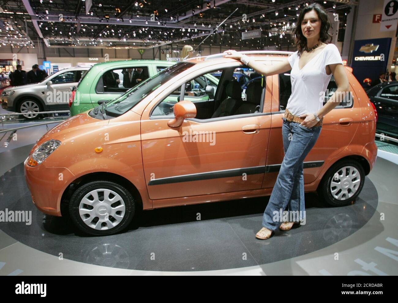 A model stands beneath the Chevrolet Matiz which is on display as a first  world presentation at the 75th Geneva motor show in Geneva, Switzerland,  March 1, 2005. The new Chevrolet Matiz