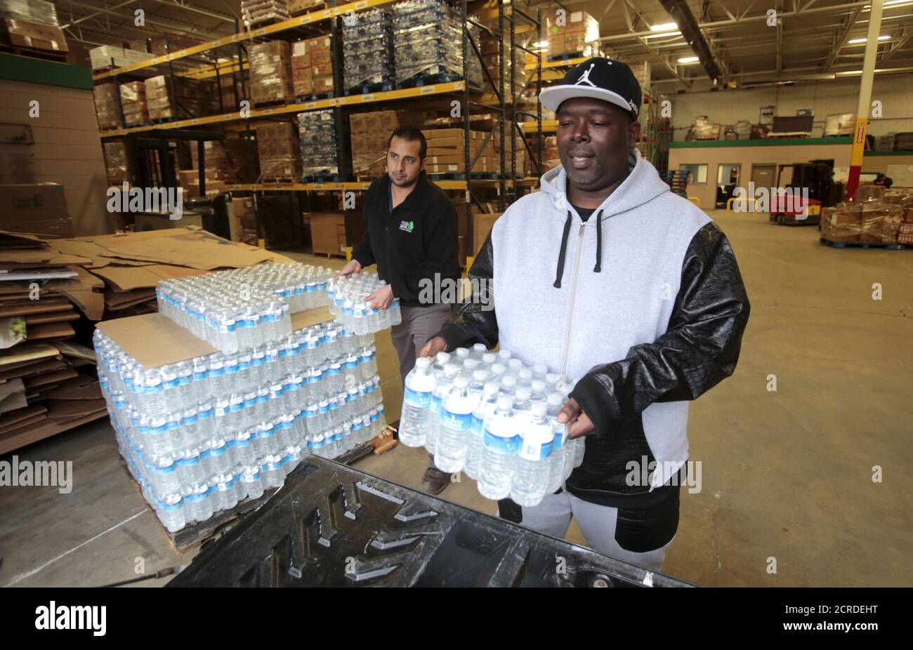 Anthony Fordham picks up bottled water from the Food Bank of Eastern Michigan to deliver to a school after elevated lead levels were found in the city's water in Flint, Michigan December 16, 2015.     REUTERS/Rebecca Cook Stock Photo