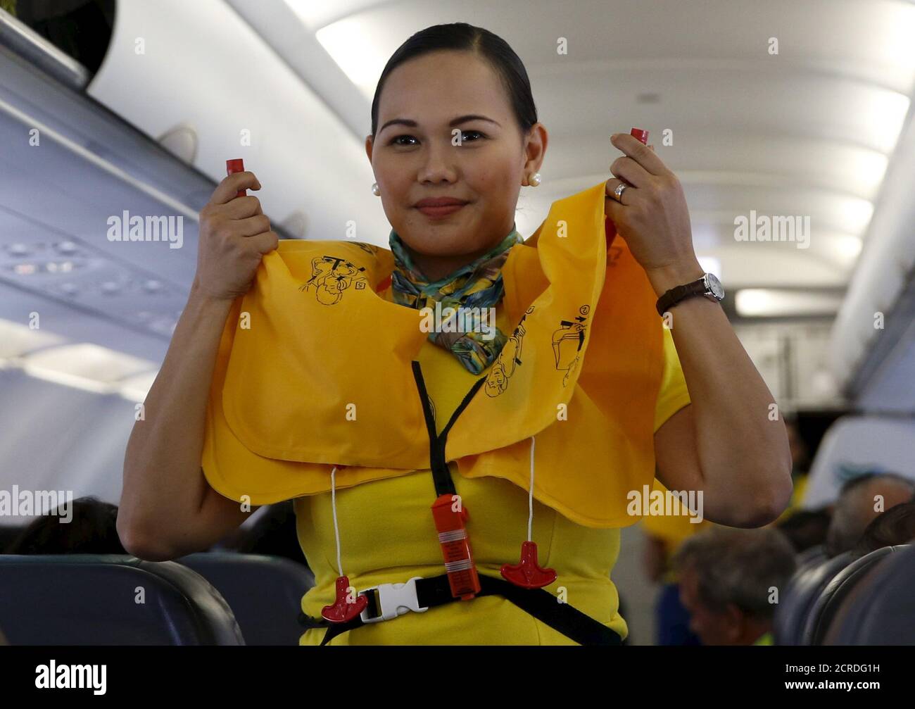 A Cebu Pacific flight stewardess demonstrates how to use a life jacket to the passengers before take off at the Terminal 3 of the Ninoy Aquino International aiport in Pasay city, Metro Manila Philippines April 1, 2016. REUTERS/Erik De Castro Stock Photo