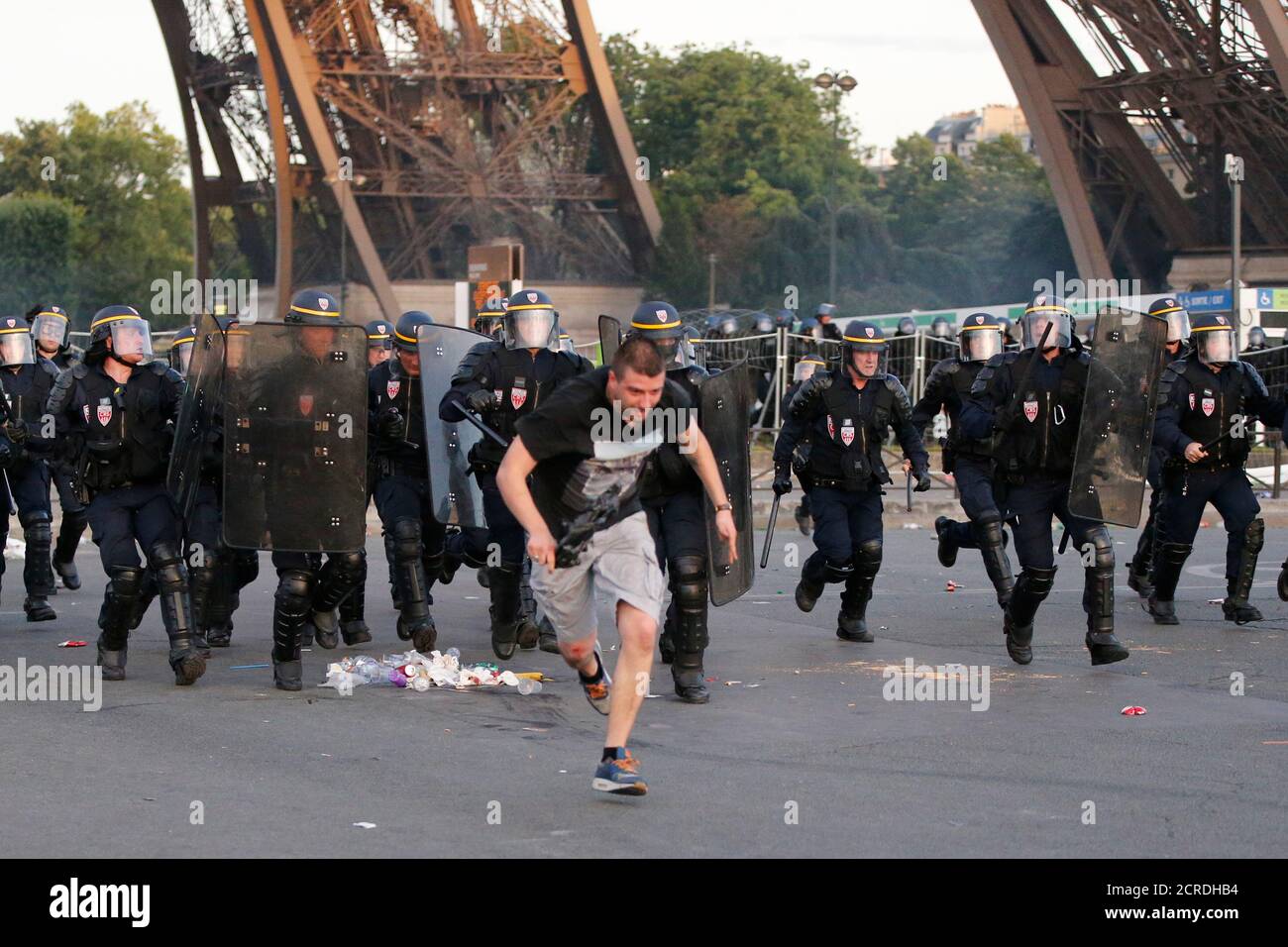 French CRS riot police charge during clashes near the Paris fan zone during the Portugal v France EURO 2016 final soccer match in Paris, France, July 10, 2016. French police fired tear gas to disperse dozens of people trying to enter the 'fan zone' at the foot of the Eiffel Tower to watch the final of the Euro 2016 soccer tournament on Sunday evening, to prevent overcrowding.      REUTERS/Stephane Mahe Stock Photo