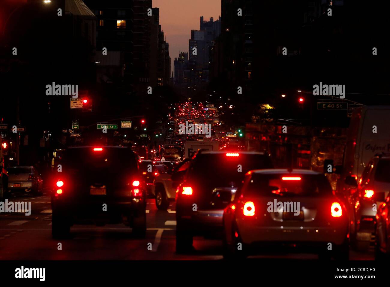 Red tail lights light up 2nd Ave as cars and trucks head downtown at sunset in the Manhattan borough of New York, New York, U.S., October 19, 2016.  REUTERS/Carlo Allegri Stock Photo
