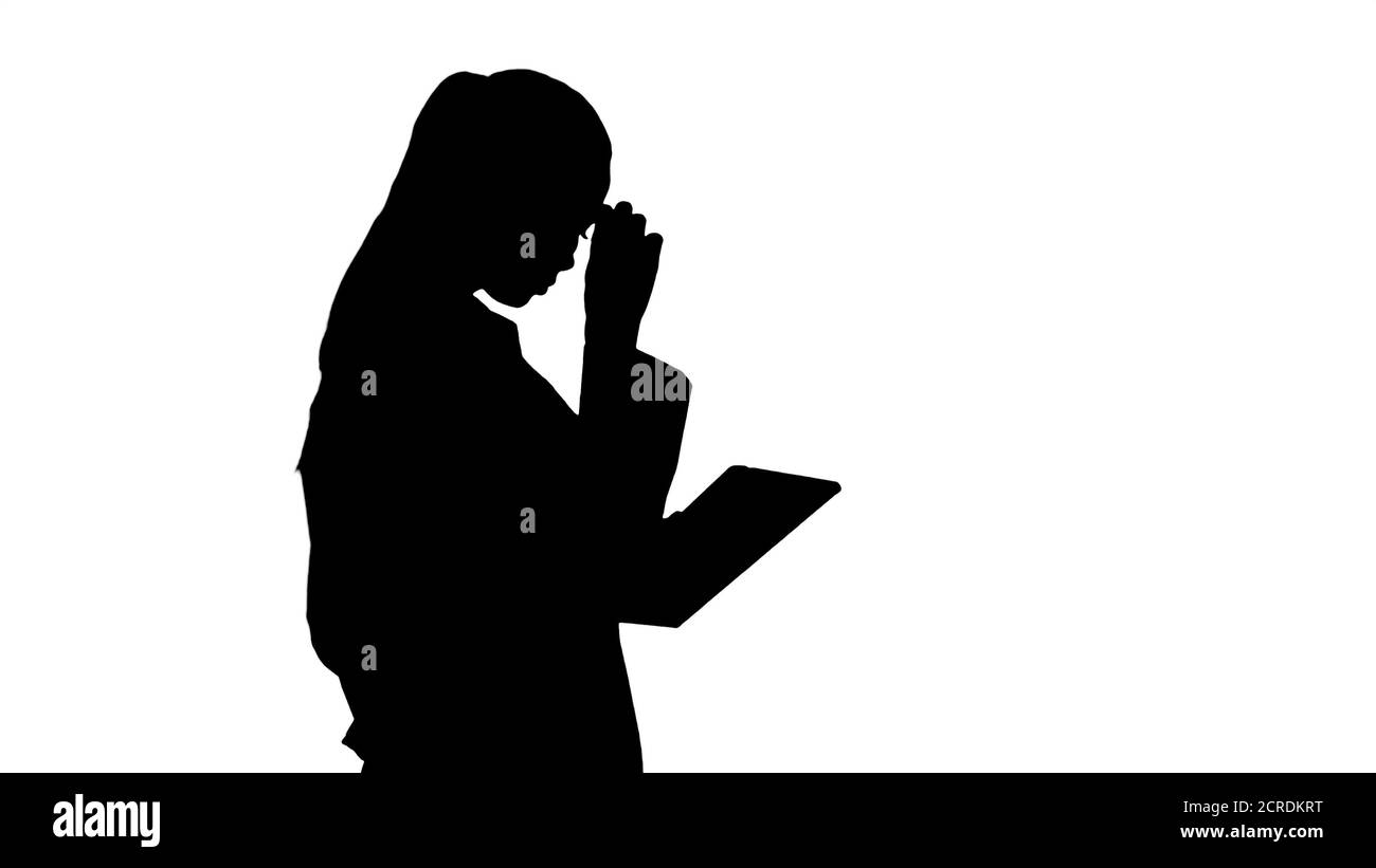 Silhouette Woman doctor using tablet pc and walking. Stock Photo