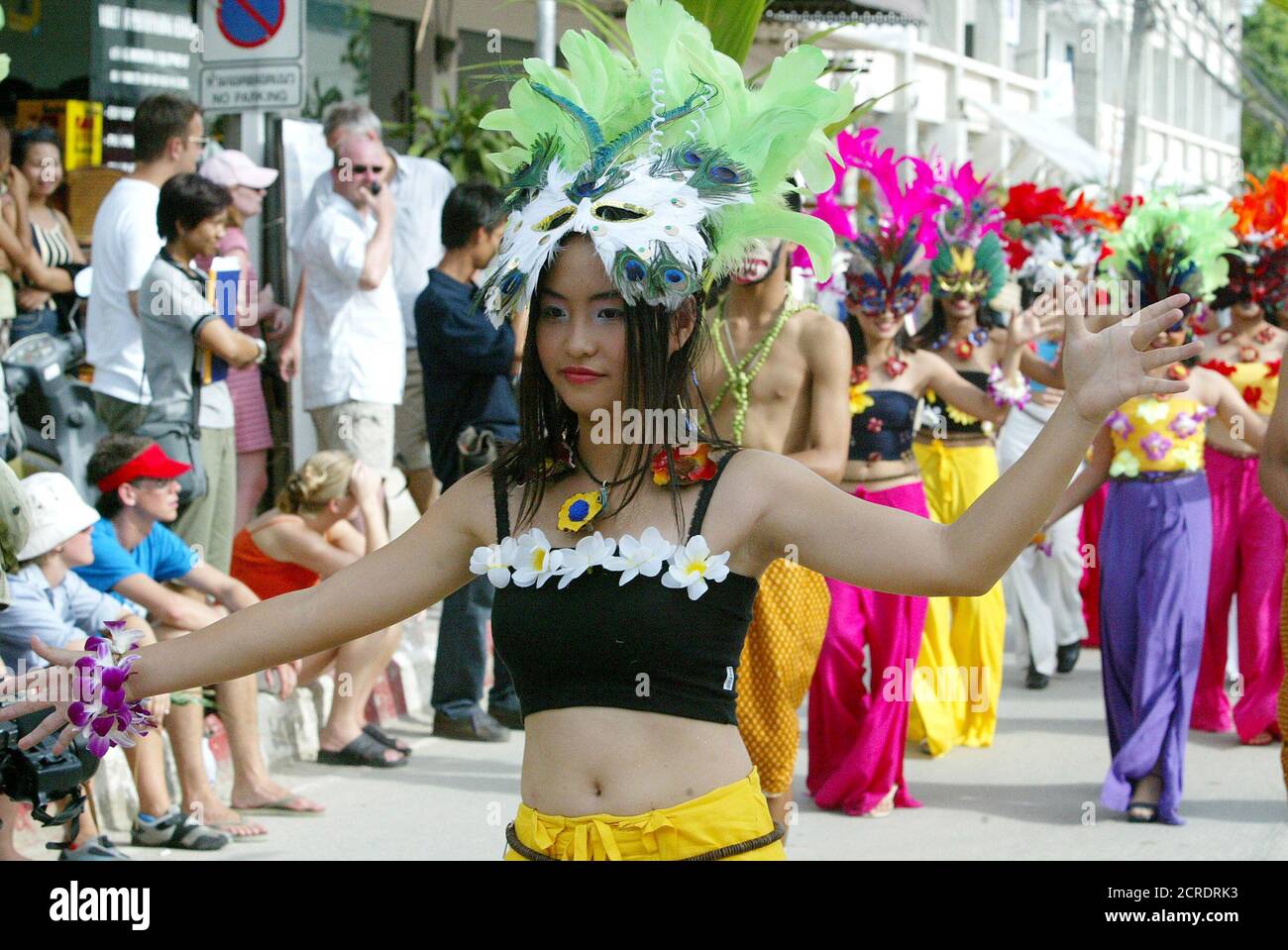 Thai ladies parade down a street in colourful dresses during the opening ceremony of the Samui Carnival 2003, July 18, 2003 in one of the tourist areas on Samui island in Surat Thani province, about 800 km (500 miles) south of Bangkok. The three day ceremony is the first ever island carnival in Asia and aims to stimulate the Thai tourism industry after the crisis caused by the SARS virus outbreak. REUTERS/Sukree Sukplang Stock Photo