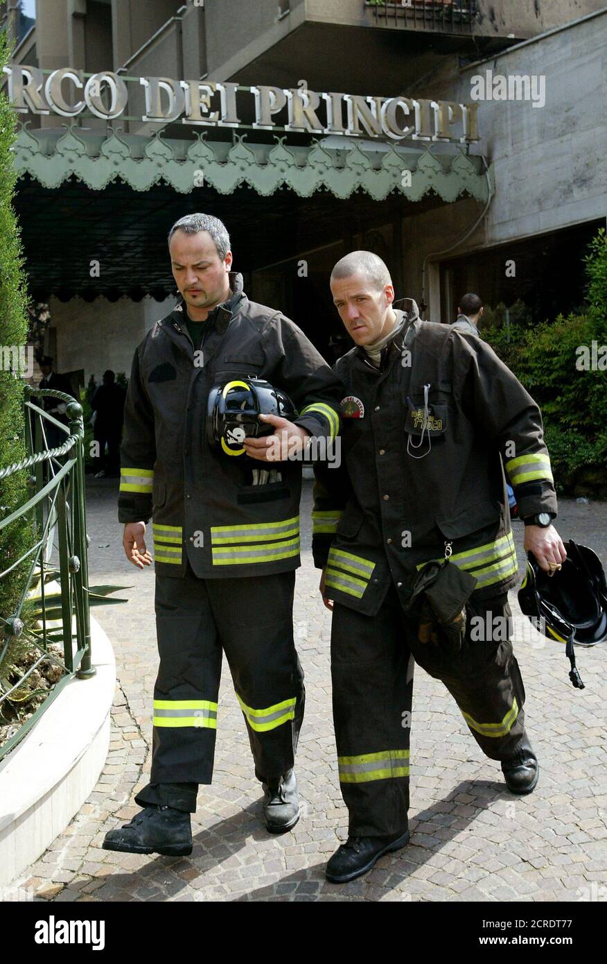 Italian firefighters leave Hotel Parco dei Principi after a fire started at around 5 a.m. local time (0300 GMT) in a room on the third floor of the hotel in Rome May 1, 2004. A Canadian couple died in a fire and an American also after throwing himself off one of the balconies of the five-star hotel trying to escape the flames. Among the guest were several tennis player in town for the Rome Open Tennis Master next week. REUTERS/Max Rossi  MR/ACM Stock Photo