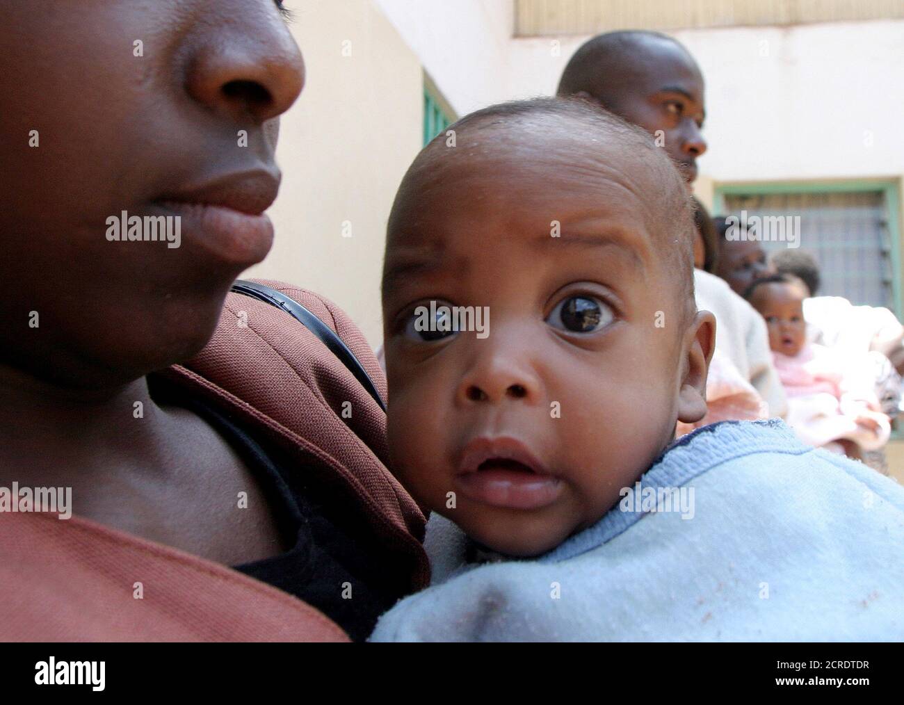 An unidentified child from a group of 20 children aged between five months and 12 years found by Kenyan authorities living with suspects of child trafficking, gazes at the camera outside Nairobi's Children home orphanage, September 6, 2004. The country started extradition proceedings on child theft charges against the British-based Kenyan pastor Gilbert Deya who says he can make infertile women pregnant. REUTERS/Thomas Mukoya  TM/RSS Stock Photo