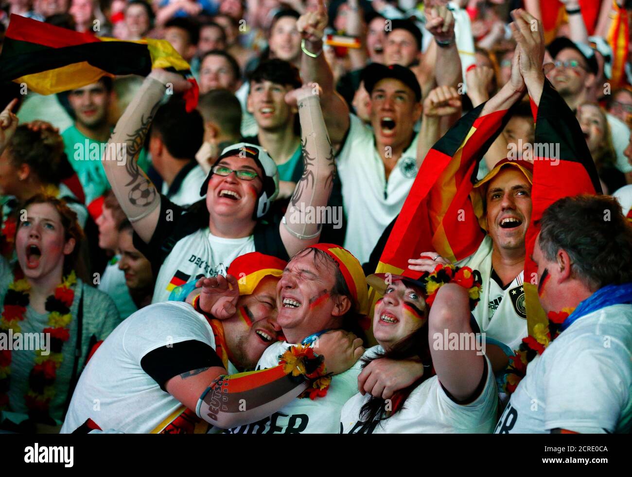 People celebrate after Germany scored against Brazil during their 2014 World Cup semi-finals, at the Fanmeile public viewing arena in Berlin July 8, 2014.  REUTERS/Thomas Peter (GERMANY - Tags: SPORT SOCCER WORLD CUP) Stock Photo