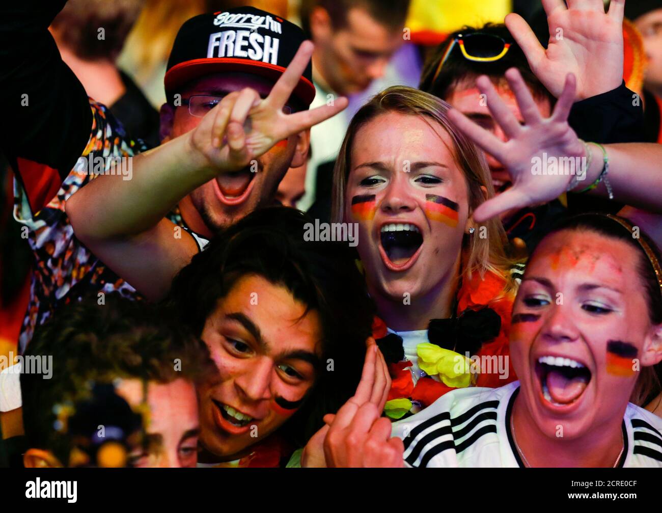 People celebrate after Germany defeated Brazil during their 2014 World Cup semi-finals, at the Fanmeile public viewing arena in Berlin July 8, 2014.  REUTERS/Thomas Peter (GERMANY - Tags: SPORT SOCCER WORLD CUP) Stock Photo