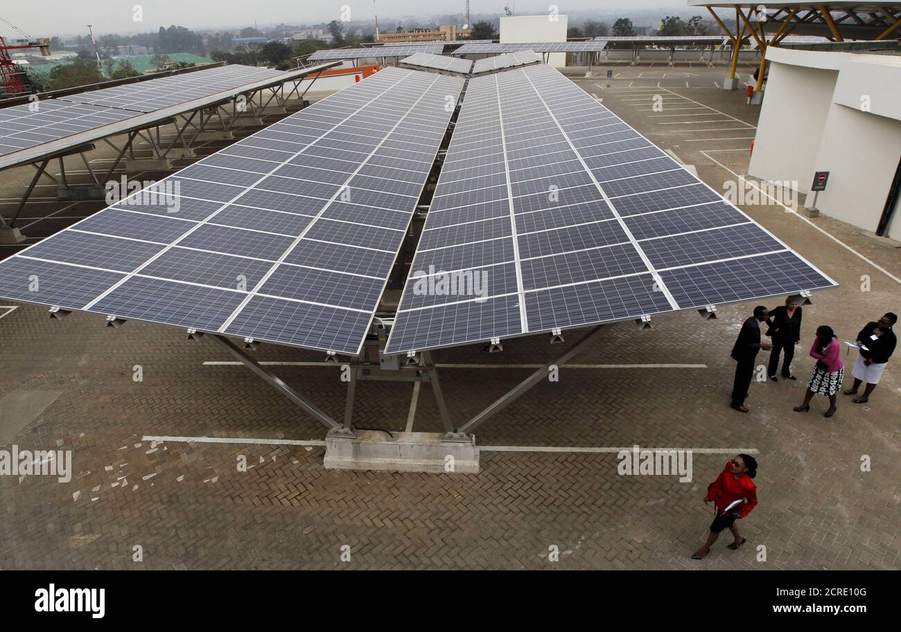 Delegates are pictured during the launch event of a solar carport at the Garden City shopping mall in Kenya's capital Nairobi, September 15, 2015. The Africa's largest solar carport with 3,300 solar panels will generate 1256 MWh annually and cut carbon emission by around 745 tonnes per year, according to Solarcentury and Solar Africa.  REUTERS/Thomas Mukoya Stock Photo
