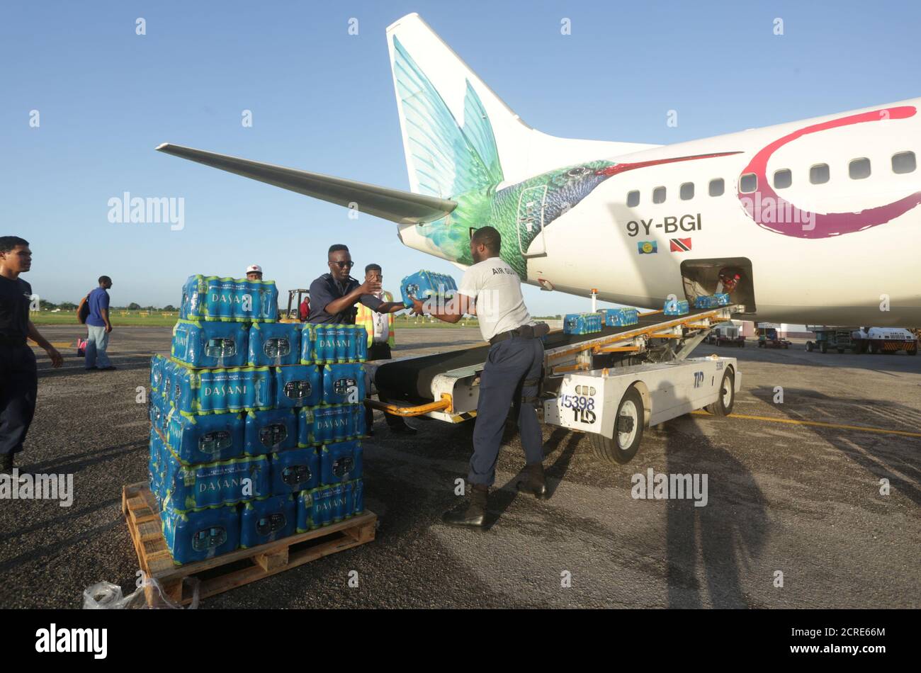 Members of Trinidad and Tobago's Air Guard load water on a relief flight organized by Caribbean airlines, for people on Sin Maarten (Saint Martin) island following Hurricane Irma, at the international airport in Piarco, Trinidad and Tobago September 16, 2017. Picture taken September 16, 2017. REUTERS/Andrea de Silva Stock Photo